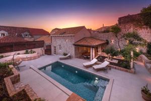 a swimming pool in the backyard of a house at Luxury villa Lia in Dubrovnik