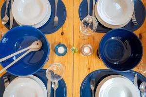 a wooden table with blue plates and silverware on it at Wohnung 5 ID 389 in Süderhöft