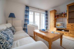 a living room with a couch and a coffee table at Wohnung 5 ID 389 in Süderhöft
