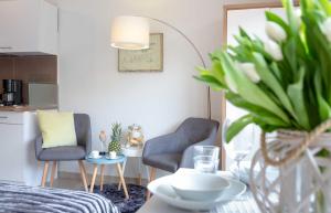 een woonkamer met twee stoelen en een tafel bij Lister Duenennest in List +7 foto's