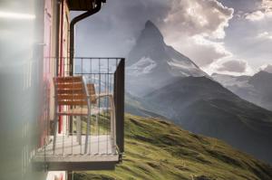 a chair sitting on the side of a mountain at Riffelhaus 1853 in Zermatt