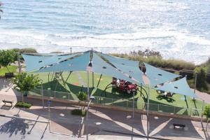 an overhead view of a circus tent by the ocean at Stunning Sea View 3BDR With Terrace By Isrentals in Netanya +17 photos