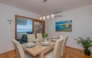 a dining room with a wooden table and chairs at Villa Mandina - Makarska by Villas Guide in Makarska