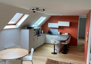 a kitchen with a table and a dining room at La Marée Grand appartement à 5 min du Touquet in Étaples