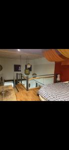 a bedroom with a bed and a dining room with a table at La chanvrière in Beaulieu-sur-Loire