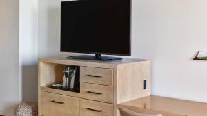a tv on top of a wooden entertainment center at Hotel Republic San Diego, Autograph Collection in San Diego