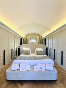 a large bedroom with a large bed with three pillows at Chateau Pimo in Draguignan +72 photos