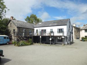 a white house with a balcony on the side of it at 8 Willow Street in Llanrwst