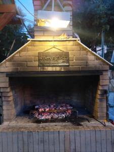 a brick oven with a bunch of chickens in it at Vila Edgon in Vlorë