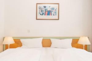 Ein Bett oder Betten in einem Zimmer der Unterkunft Seepark Sellin FeWo AG Whg 383