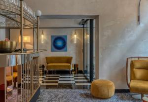 a lobby with two chairs and a table at Hotel Experior Boutique - Destigo Hotels in Krakow