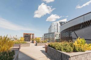 a view of a campus with benches and buildings at Wallesmanni - Nokia Arena prime location apartments by Come in! in Tampere