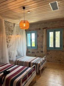 a bedroom with two beds and a chandelier at Masarya house in Marmaris +30 photos