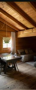 a room with a table and a bed in a cabin at Oberortlhof bei Juval in Castelbello-ciardes
