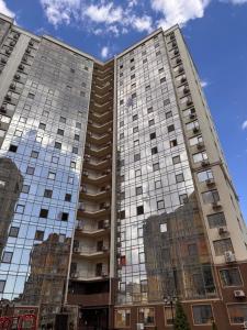 a tall building with a lot of windows at Апартаменты-студия с видом на море ЖК Kadorr 10 жемчужина in Odesa