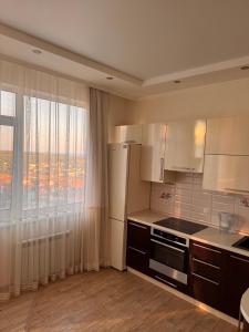 a kitchen with white appliances and a large window at Апартаменты-студия с видом на море ЖК Kadorr 10 жемчужина in Odesa +2 photos