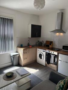 a kitchen with a washer and dryer in a room at Central Location 1 Double Bedroom Apartment 7 in Blackpool +5 photos