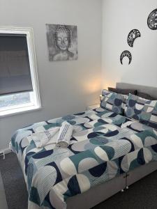 a bedroom with a bed with a blue and white comforter at Central Location 1 Double Bedroom Apartment 7 in Blackpool