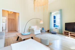 a living room with a couch and a table at ARTEMIS SUITE in Agia Marina