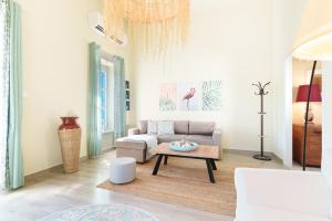 a living room with a couch and a coffee table at ARTEMIS SUITE in Agia Marina