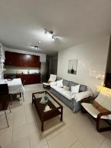 a living room with a couch and a table at Sirena Del Mar in Pefkohori
