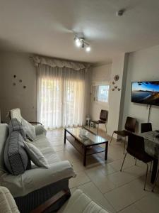 a living room with a couch and a table at Sirena Del Mar in Pefkohori