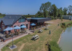 an overhead view of a restaurant with tables and umbrellas at Herons Mead Cottages in Orby
