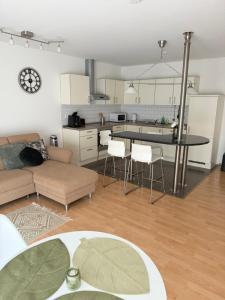 a living room with a couch and a table with a clock at Private Apartment with Terrace and Parking in Dortmund +12 photos