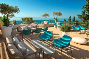 a group of chairs and tables on a patio at Radisson Blu Resort & Spa in Split