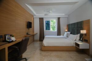 a hotel room with a bed and a desk and a computer at LUXUS INN in Dhanbād +37 photos