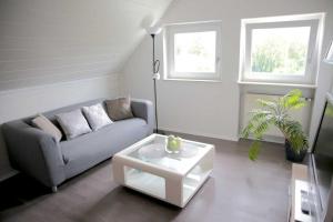 a living room with a couch and a coffee table at Ferienwohnungen Riedel in Pegnitz