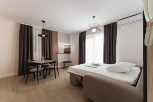 a hotel room with a bed and a table at Villa Malo More in Trogir