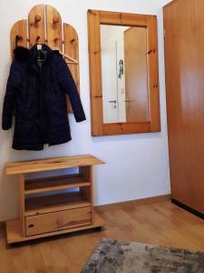 a coat hanging on a wall next to a mirror at Oberbremer, Heidweg 6 in Nieblum +1 photo