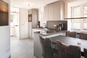 a kitchen with a table and chairs in a room at Family&Friends in Wyk auf Föhr
