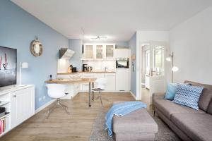 a living room with a couch and a kitchen at Wiesenglück in Wyk auf Föhr +10 photos