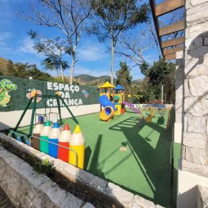 einen Spielbereich mit einem Spielplatz mit Rutsche in der Unterkunft Casa de Campo com Lago e Jardim - Pet-Friendly in Miguel Pereira