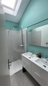 a bathroom with a sink and a shower and a mirror at Maison de vacances à 200m de la mer in Plouha +8 photos