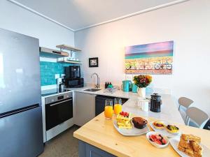 a kitchen with two plates of food on a counter at Wavescapes Tides Stay in Muizenberg