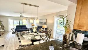 a kitchen and living room with a table and chairs at Just minutes from the beach Boca Raton in Boca Raton