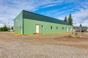 a green building with a door in a parking lot at Less Than 2 Mi to Dtwn Pet-Friendly Getaway in Fairbanks in Fairbanks