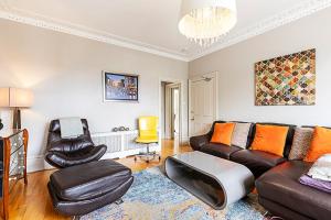 a living room with a couch and two chairs at Super Chic 1-Bedroom Urban Hideaway in Twickenham