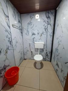 a bathroom with a toilet and a bucket at Paradise beach homestay in Alleppey +75 photos