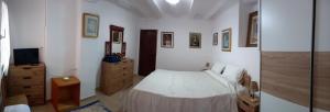 a bedroom with a bed and a tv on a dresser at Casa De Giulio in Cocentaina +7 photos
