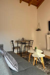 a living room with a couch and tables at Salitzo Apartment Palairos in Paleros