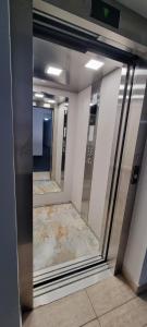 a reflection of a hallway with mirrors in a building at Hotel Blue Sky Resort in Eforie Nord