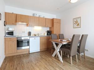 a kitchen with a table and chairs in a room at Residenz Haffblick in Boltenhagen