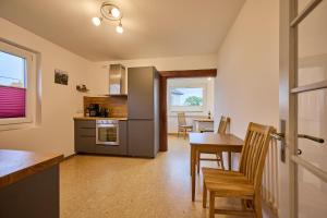 a kitchen and dining room with a table and chairs at Idyllische Ruhe Der Villa Hedwig in Kurort Gohrisch