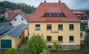 a yellow house with a red roof at Idyllische Ruhe Der Villa Hedwig in Kurort Gohrisch