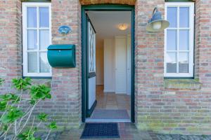 a door leading into a brick building with a mailbox at Stine Marie 1 in Borgsum