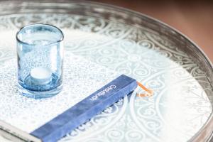 a glass sitting on top of a plate with a book at Haus Evje in Utersum +17 photos